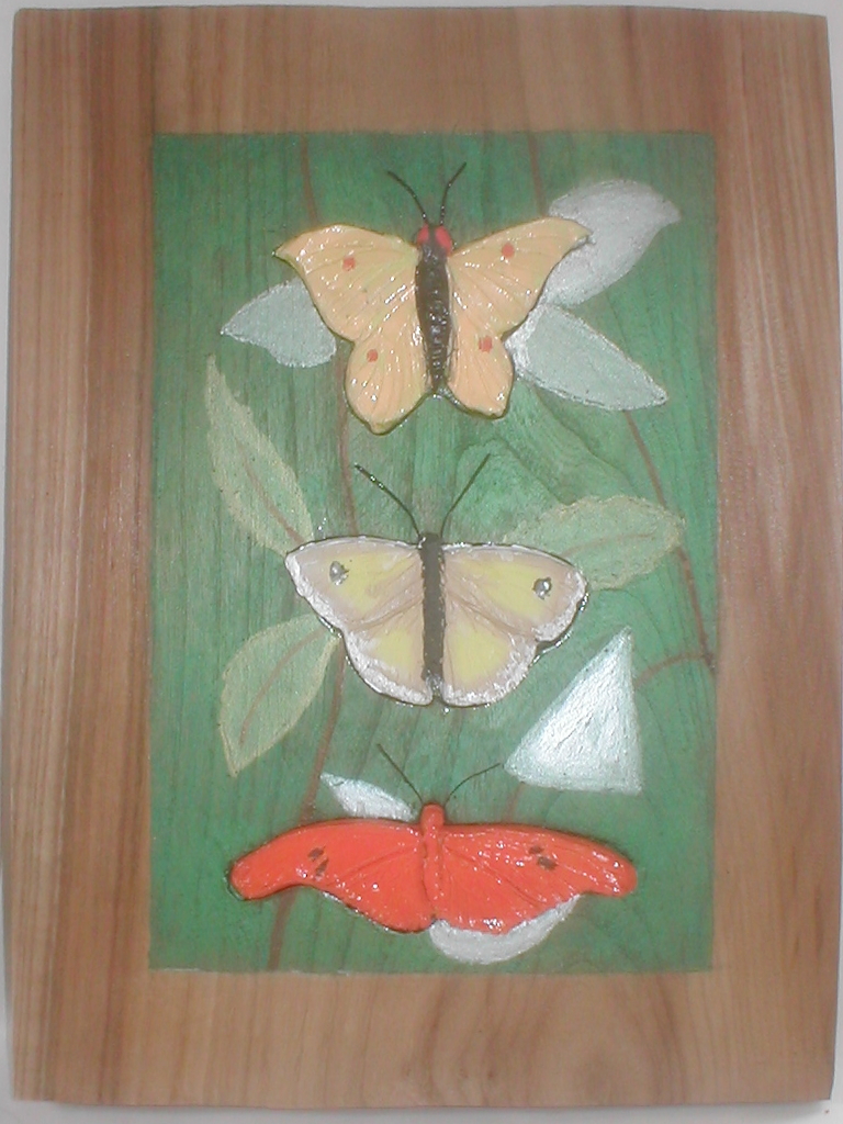 Three pottery butterflies on elm